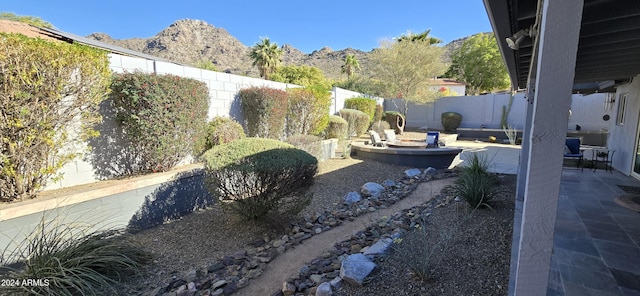 view of yard with a patio area and a mountain view