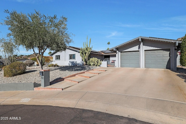 ranch-style house featuring solar panels and a garage