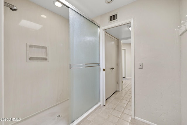 bathroom featuring a shower with shower door