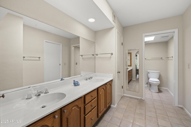 bathroom featuring tile patterned floors, vanity, and toilet