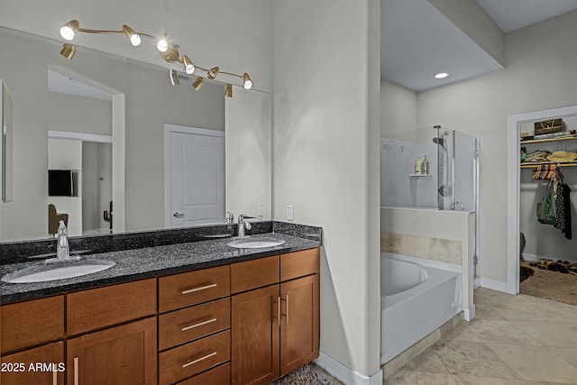 bathroom featuring tile patterned flooring, vanity, and plus walk in shower