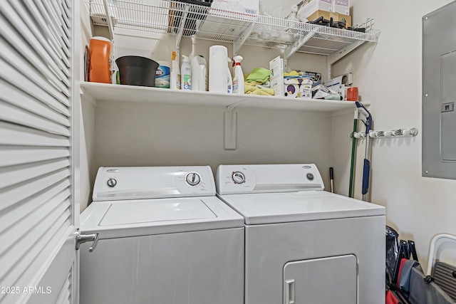 clothes washing area featuring electric panel and independent washer and dryer