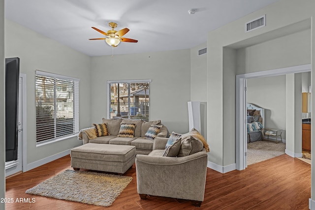 living room featuring wood-type flooring and ceiling fan