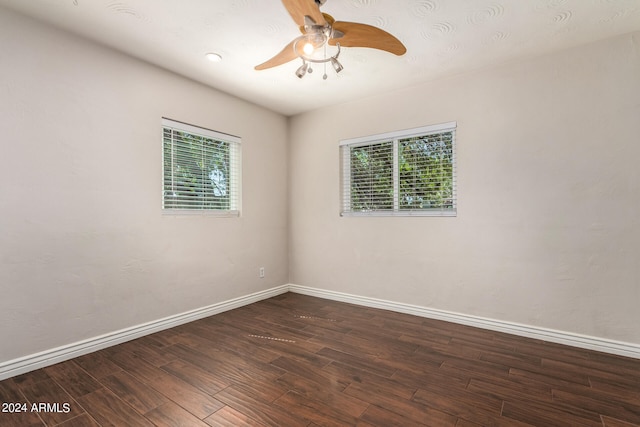 empty room featuring ceiling fan and dark wood-type flooring