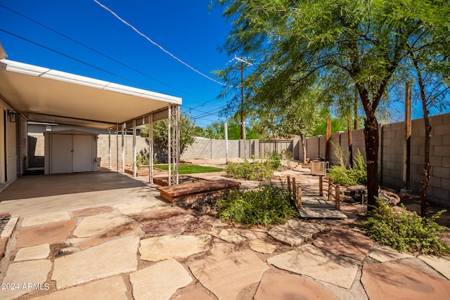 view of patio / terrace with a storage shed