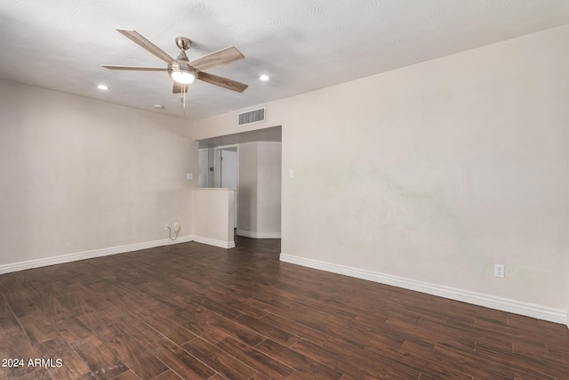 spare room featuring dark hardwood / wood-style flooring and ceiling fan