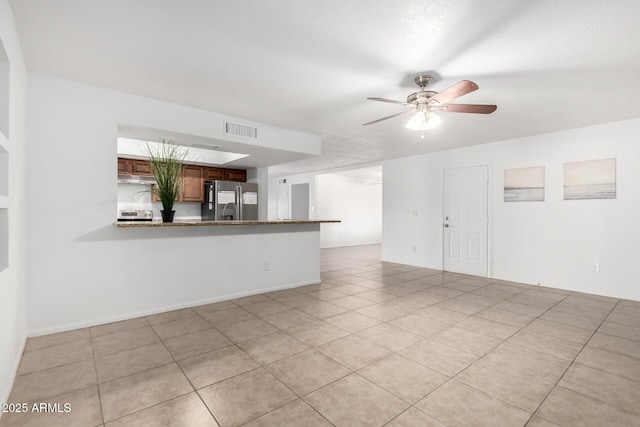 unfurnished room with light tile patterned flooring, visible vents, and a ceiling fan