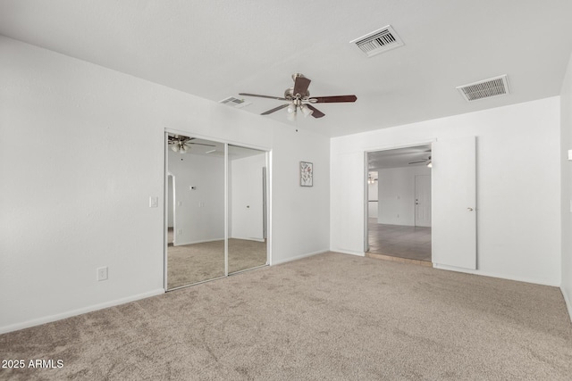 unfurnished bedroom with carpet floors, a closet, and visible vents