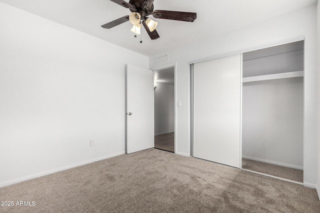 unfurnished bedroom featuring a closet, carpet flooring, visible vents, and baseboards