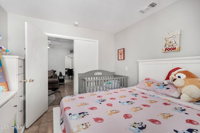 bedroom with visible vents and light tile patterned floors