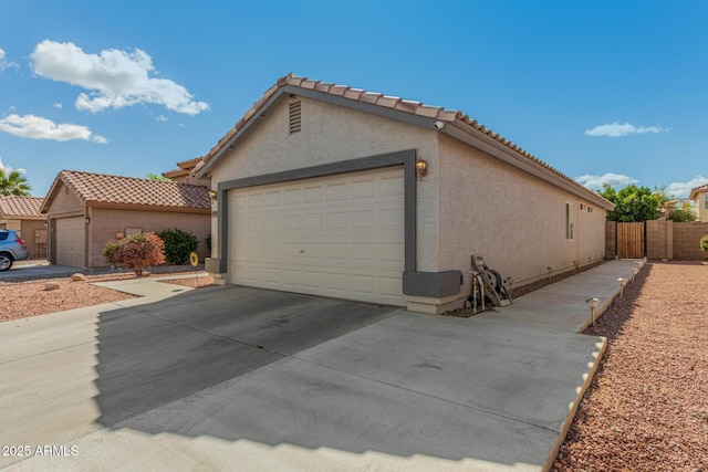 exterior space featuring driveway and fence