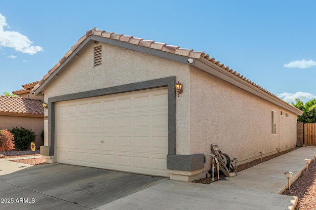 view of home's exterior featuring a garage, driveway, and stucco siding