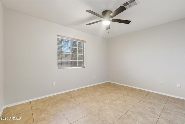 tiled empty room featuring ceiling fan