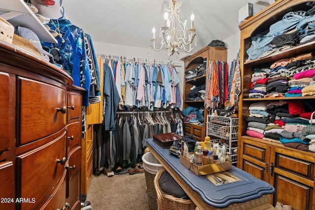 walk in closet featuring carpet and a notable chandelier