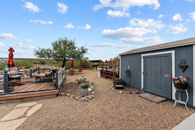 view of yard with a shed and a wooden deck