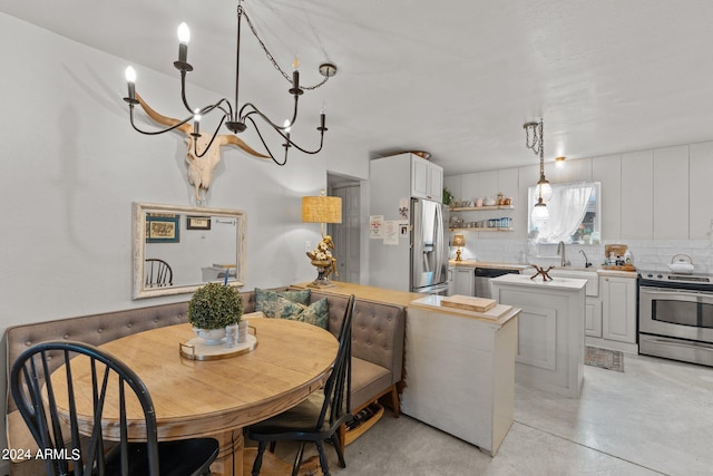 dining room featuring a chandelier and sink