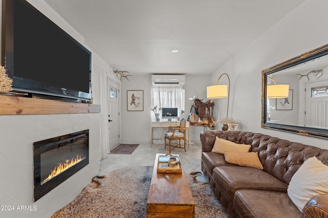 living room with a wall mounted air conditioner and concrete floors