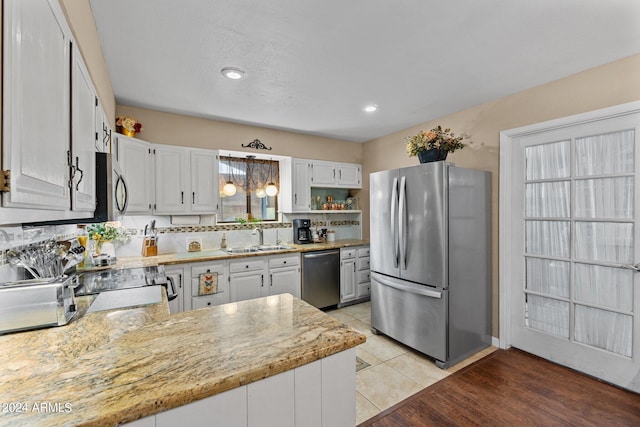 kitchen featuring white cabinetry, stainless steel appliances, sink, and tasteful backsplash