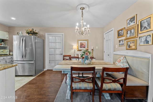 dining area featuring an inviting chandelier and light hardwood / wood-style floors