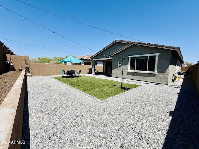 1657 W Monte Way, Phoenix, AZ 85041 - rear view of house featuring stucco siding, a fenced backyard, and a patio area