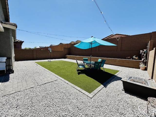 1657 W Monte Way, Phoenix, AZ 85041 - fenced backyard featuring an outdoor fire pit and a patio area