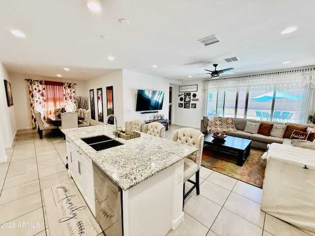 1657 W Monte Way, Phoenix, AZ 85041 - kitchen featuring open floor plan, light tile patterned flooring, dishwashing machine, recessed lighting, and light stone counters