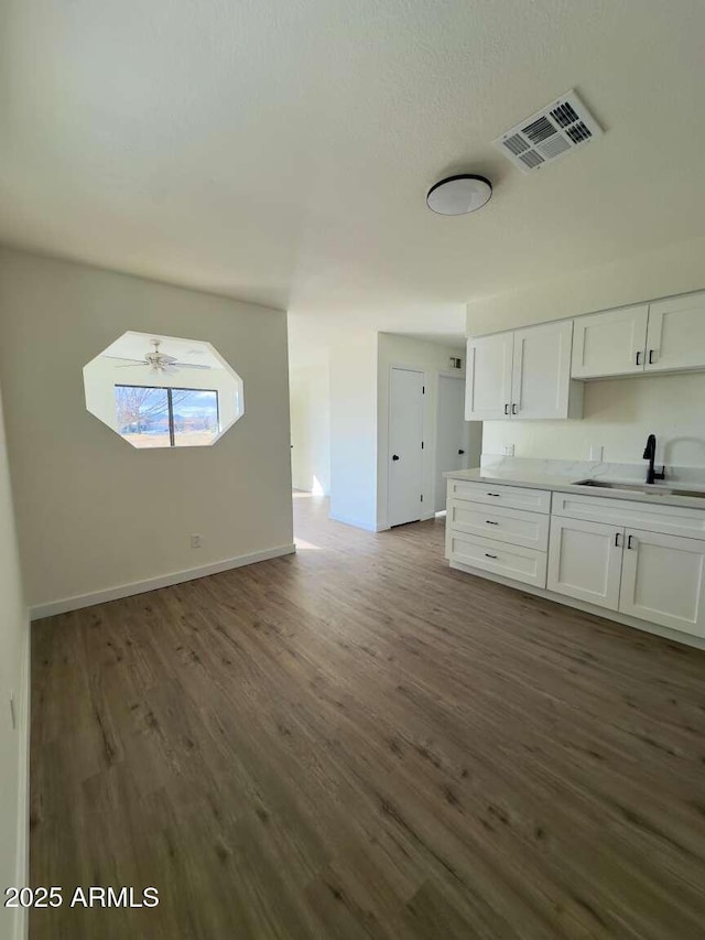 kitchen with sink, dark hardwood / wood-style floors, and white cabinets