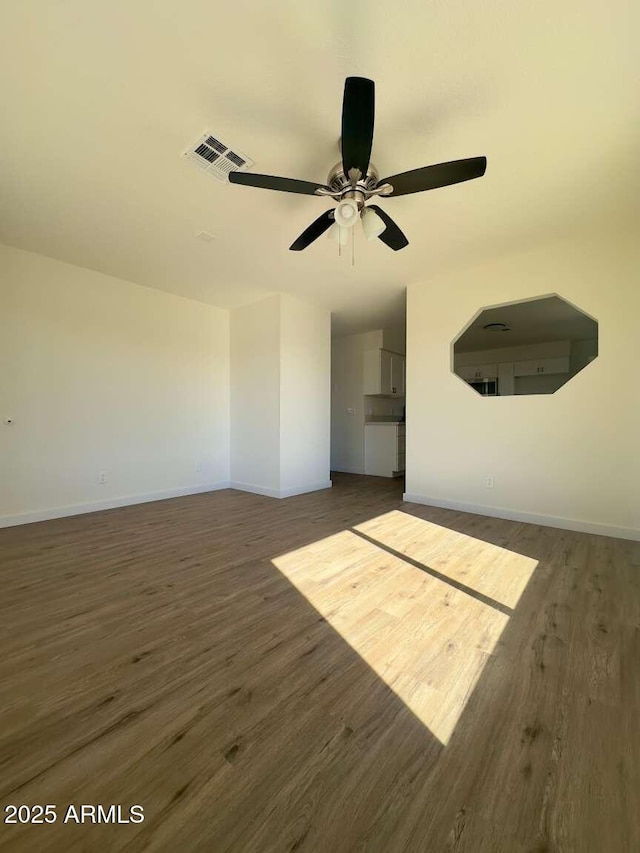 interior space with ceiling fan and dark hardwood / wood-style flooring