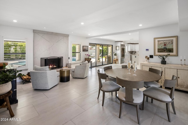 dining area featuring a premium fireplace and a wealth of natural light