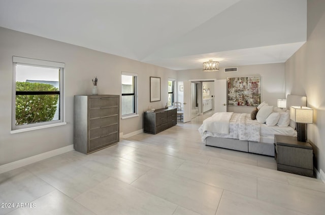 bedroom featuring vaulted ceiling and an inviting chandelier