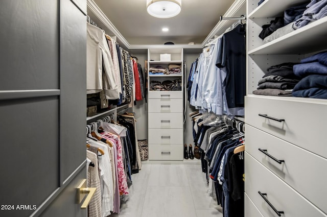 walk in closet with light tile patterned floors