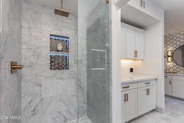 bathroom with vanity and tiled shower