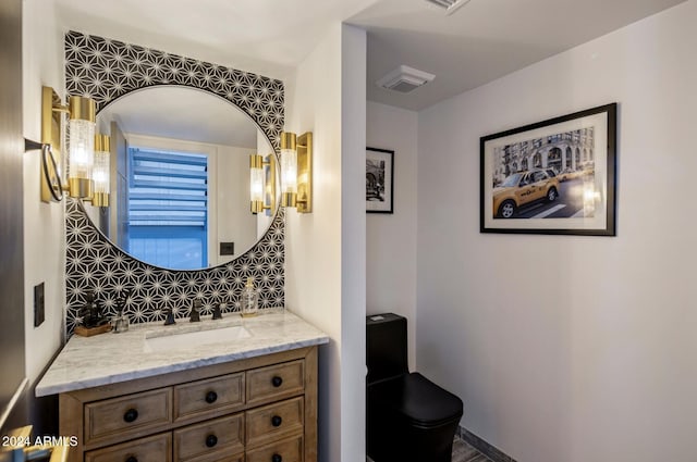 bathroom featuring vanity and backsplash