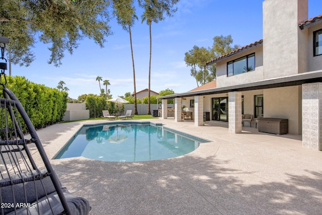 view of pool with a patio area and exterior bar