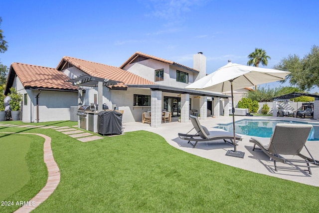 rear view of property with a fenced in pool, a patio, a yard, and a pergola