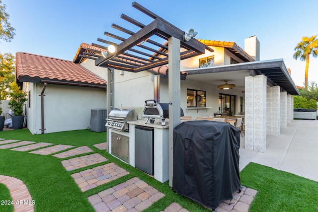 view of patio / terrace featuring cooling unit, grilling area, a pergola, and exterior kitchen