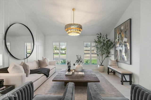 living room featuring vaulted ceiling and a chandelier