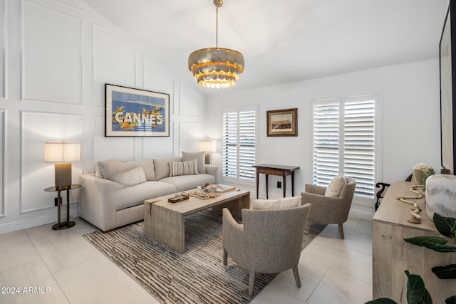 tiled living room with an inviting chandelier and vaulted ceiling