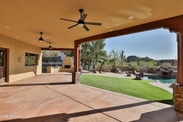 view of patio / terrace with a fenced in pool, ceiling fan, and area for grilling
