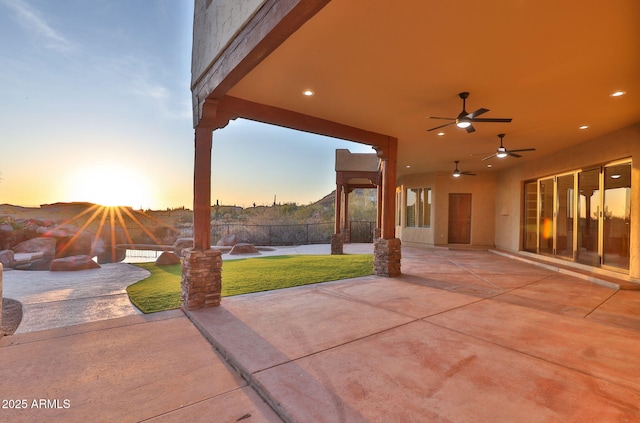view of patio / terrace featuring fence and ceiling fan