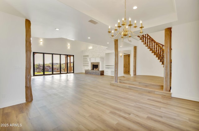 unfurnished living room with lofted ceiling, visible vents, light wood finished floors, and recessed lighting