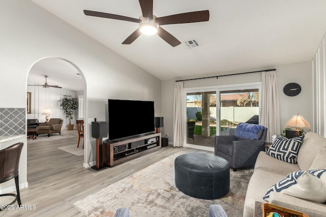 living room with lofted ceiling and light hardwood / wood-style flooring