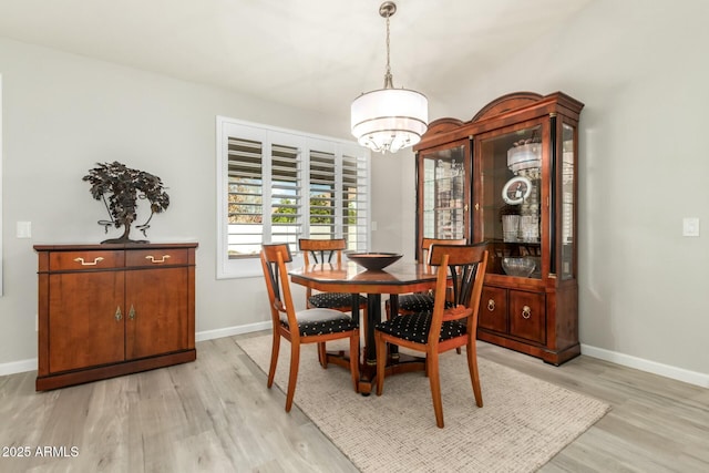 dining room featuring an inviting chandelier and light hardwood / wood-style floors