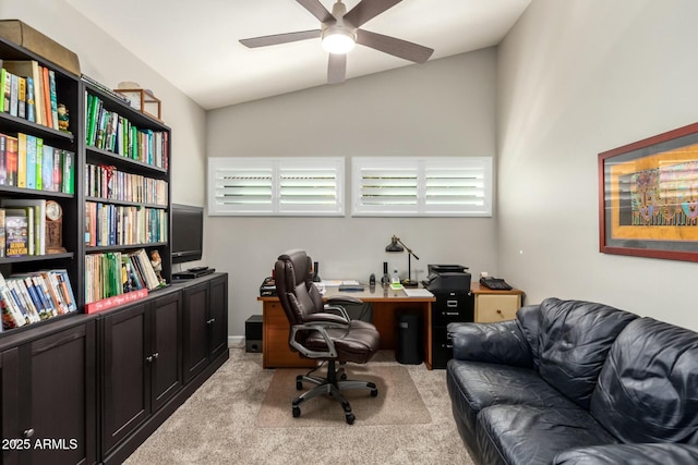 home office with ceiling fan, light colored carpet, and lofted ceiling