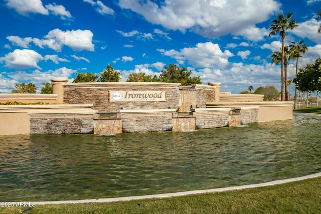 community / neighborhood sign featuring a water view