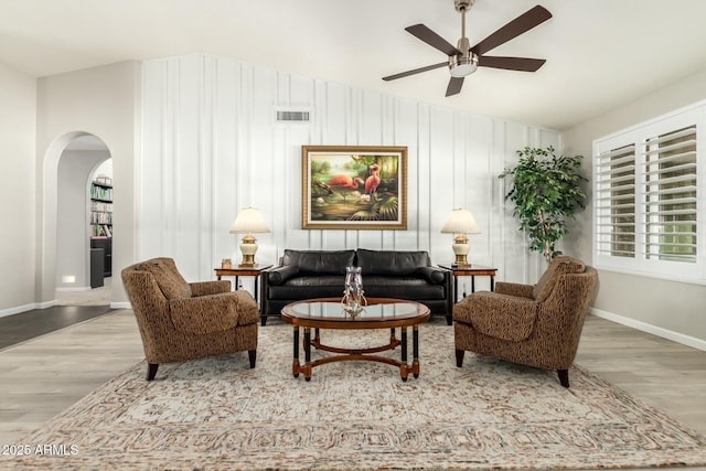 living area with ceiling fan and light hardwood / wood-style flooring