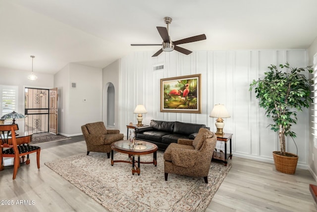 living room featuring ceiling fan and light hardwood / wood-style floors