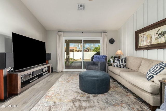 living room featuring light hardwood / wood-style flooring and lofted ceiling