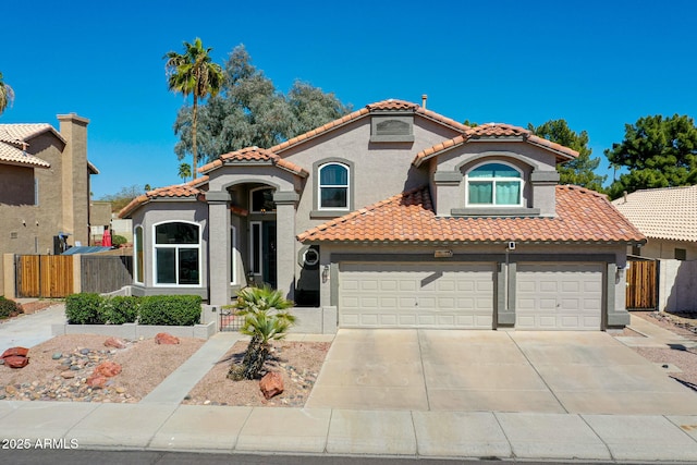 mediterranean / spanish-style house featuring fence, stucco siding, concrete driveway, a garage, and a tile roof