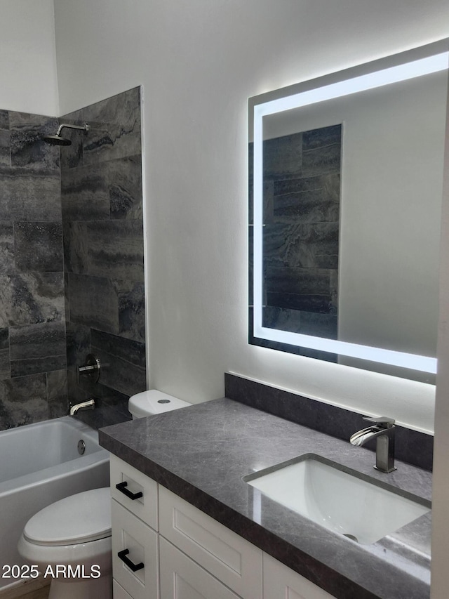 full bathroom featuring vanity, toilet, and tiled shower / bath